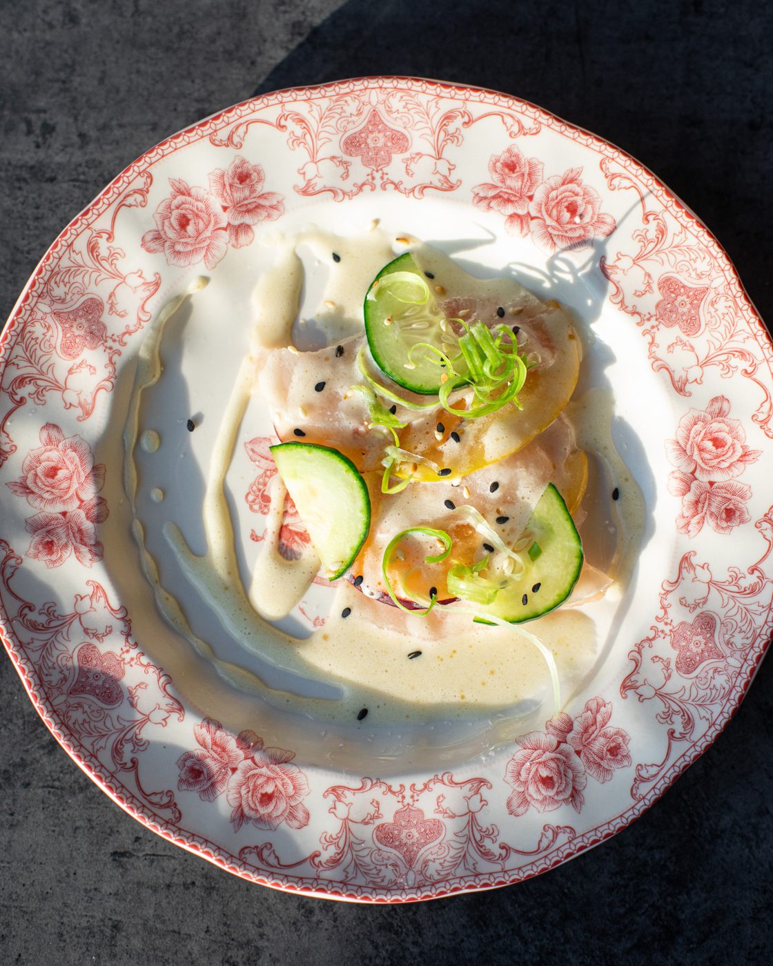 Crudo with lime and chili on a floral plate